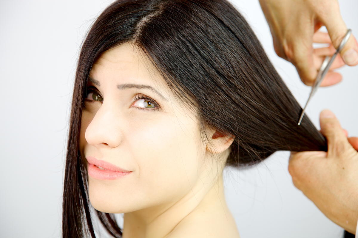 Woman about to have long hair cut off
